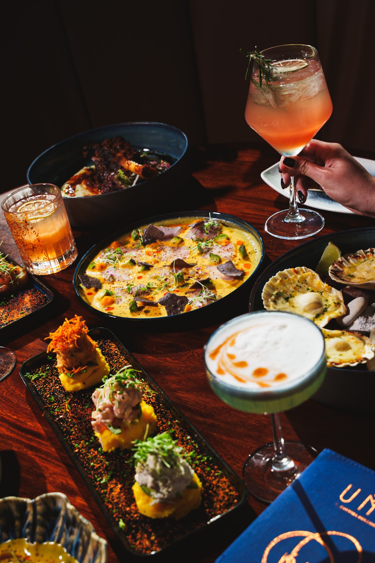 A spread of UMA dishes and cocktails